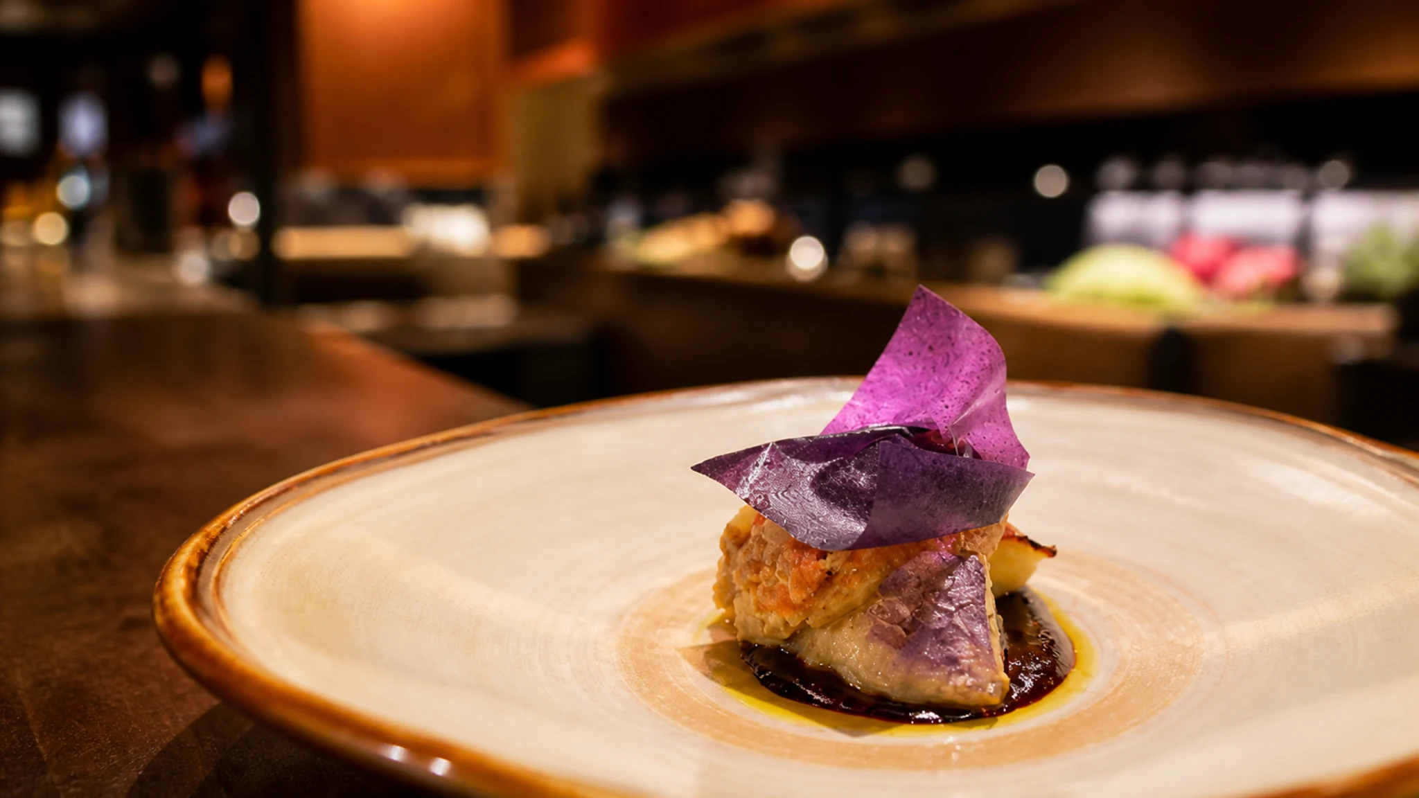 Den Kushi Flori Tokyo small tasting menu dish with purple garnish and sauce