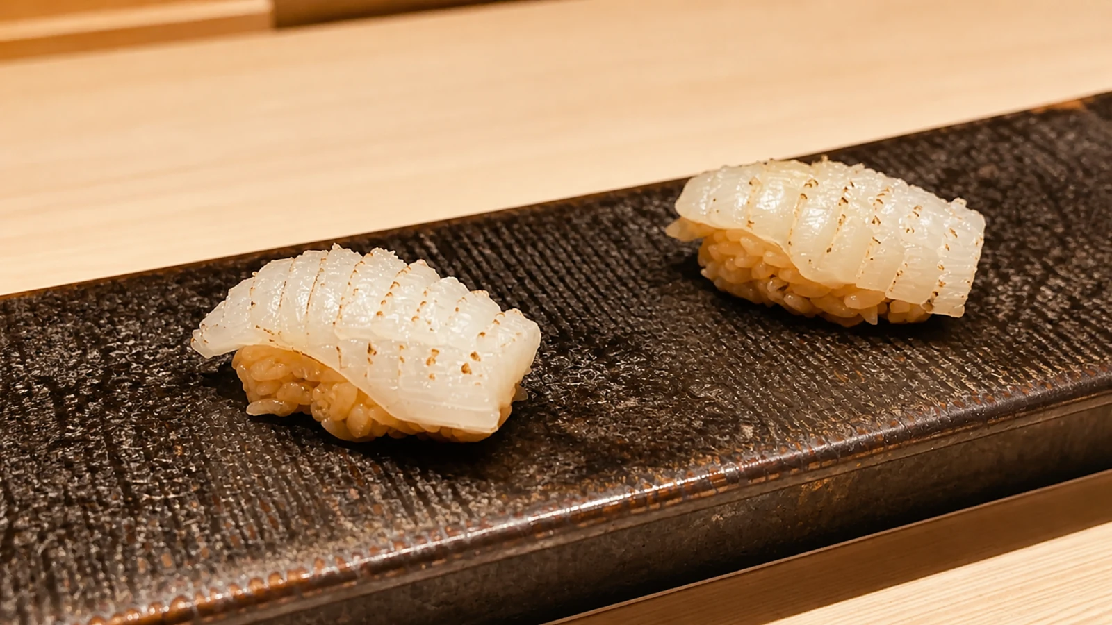 Sushi Hatsume Tokyo nigiri sushi pieces served on a black ceramic plate