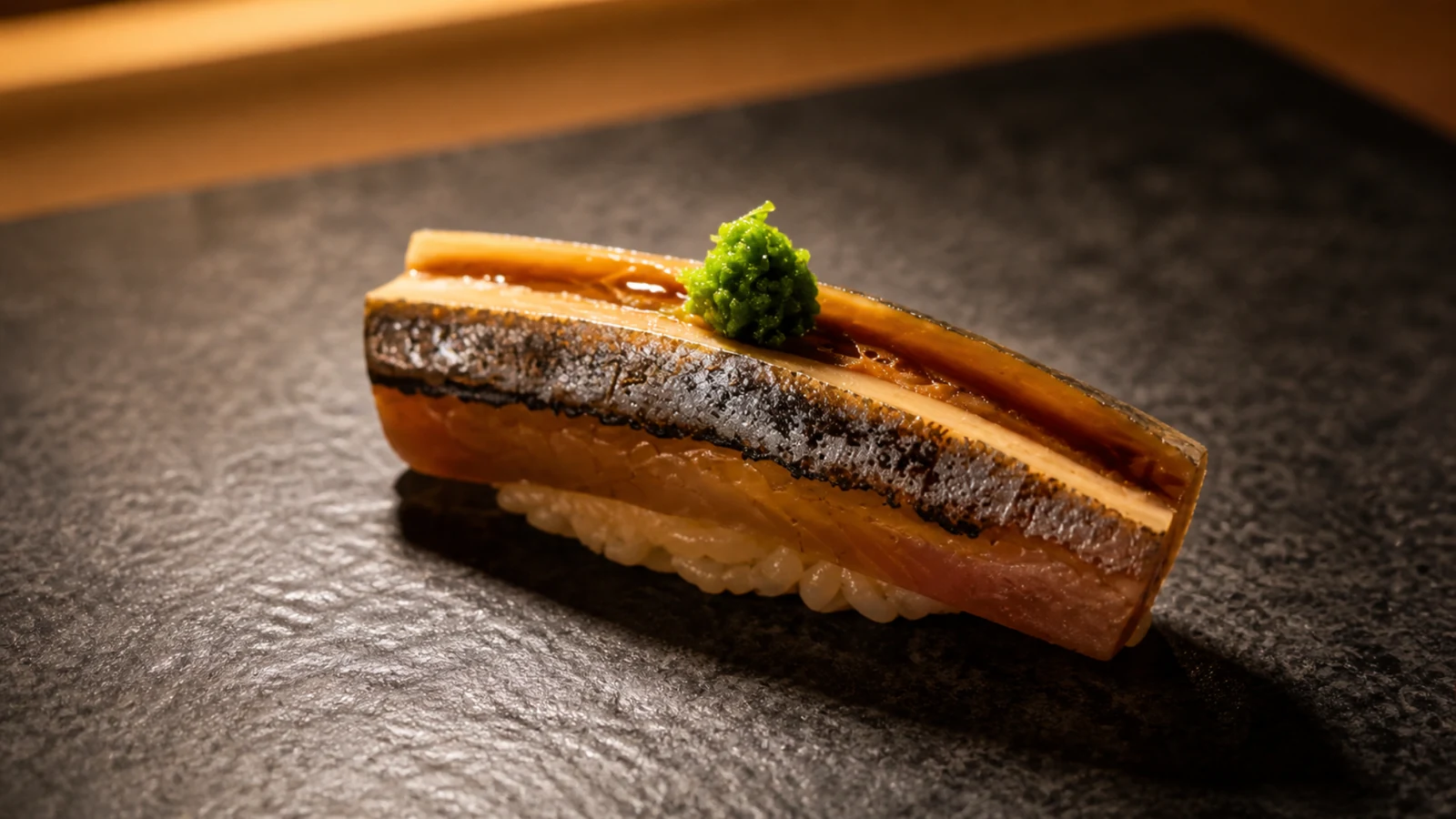 Sushi FUKUZUKA Tokyo single nigiri sushi piece served on a dark plate