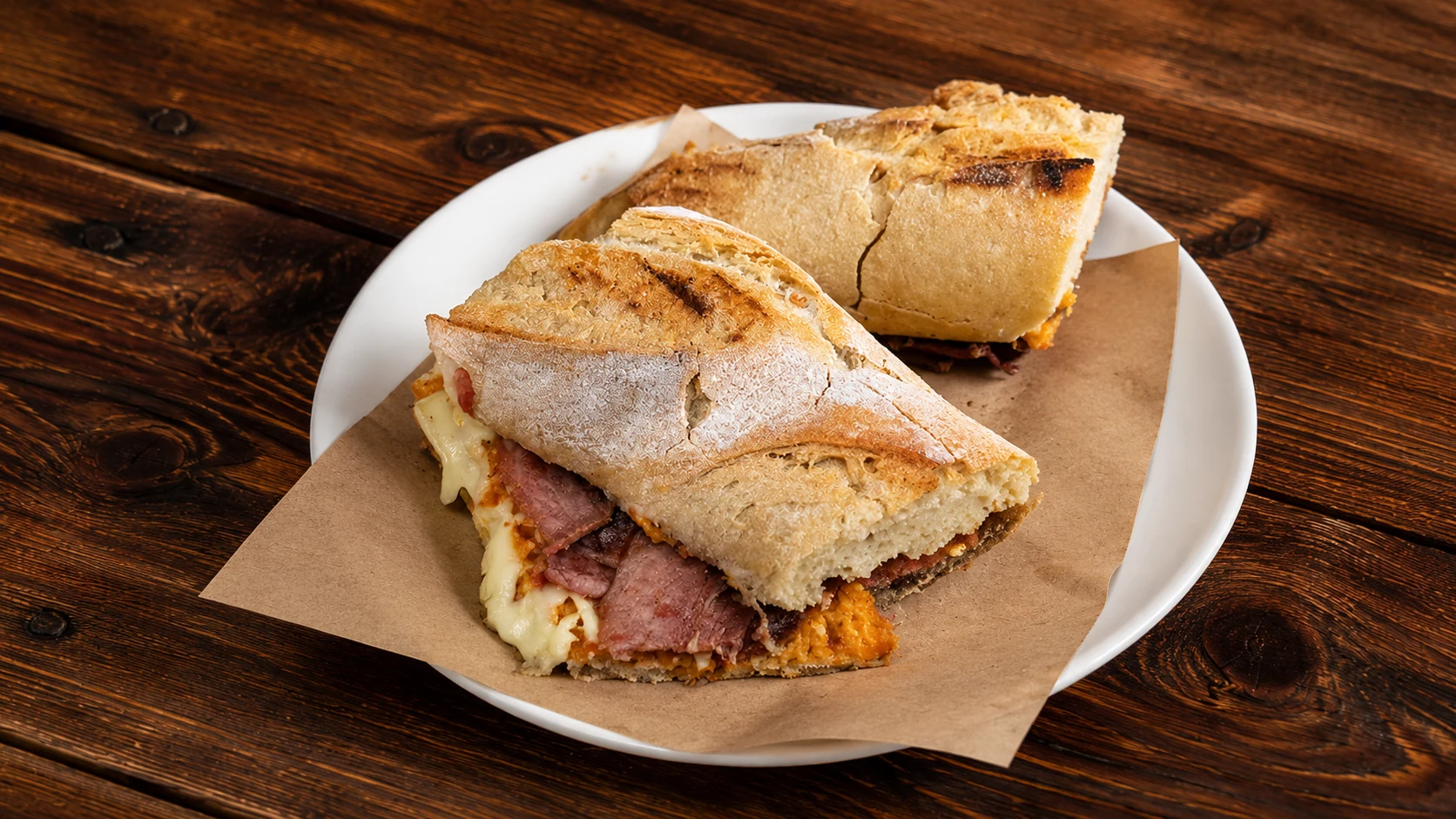 Bodega Montferry Barcelona bocadillo sandwich with cured meat on a wooden table