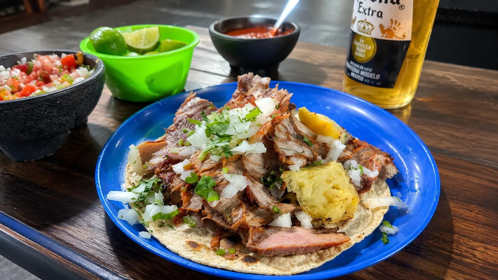 El Vilsito Mexico City tacos al pastor with pineapple, salsa, lime, and beer