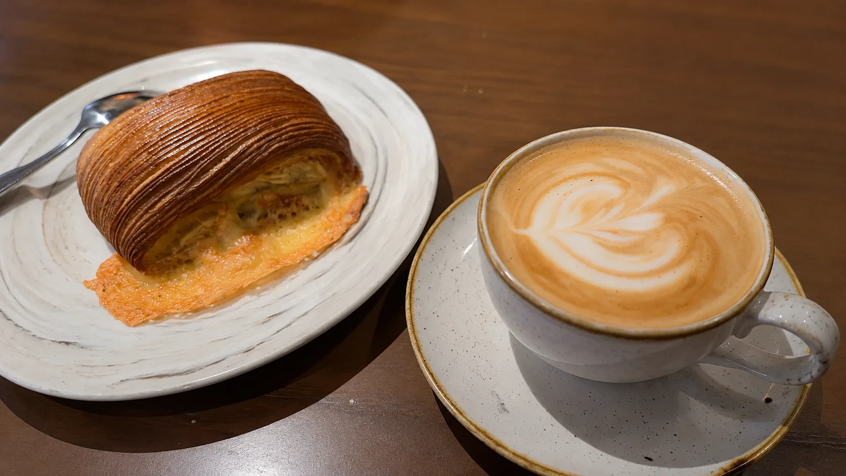 Latte and pastry on a plate at Good Ambler in Chicago