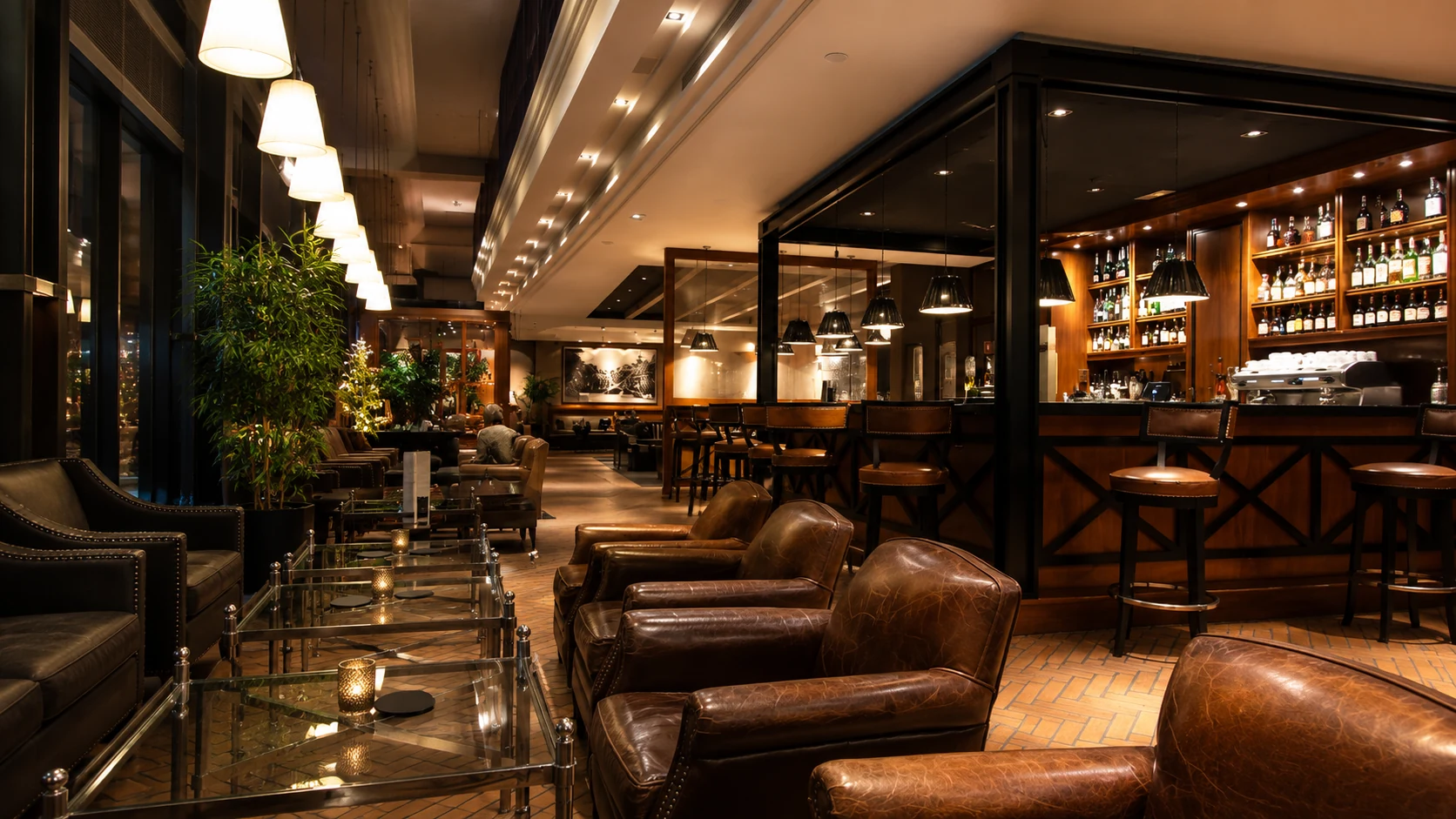 Hotel 1898 Barcelona lounge bar with leather seating, warm lighting, and a classic upscale hotel feel