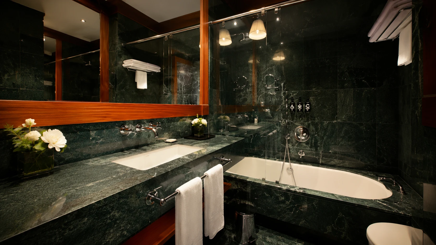 Hotel 1898 Barcelona marble bathroom with dark green stone and glass shower