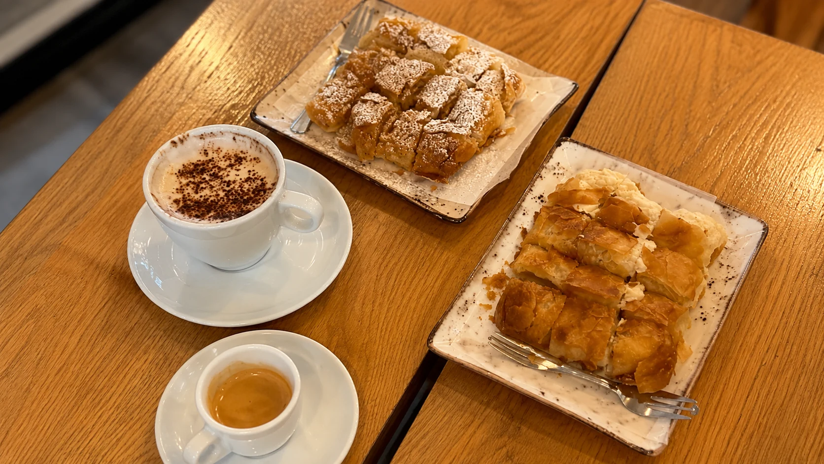 Kafenion Barcelona coffee, pastry, and small breakfast plate