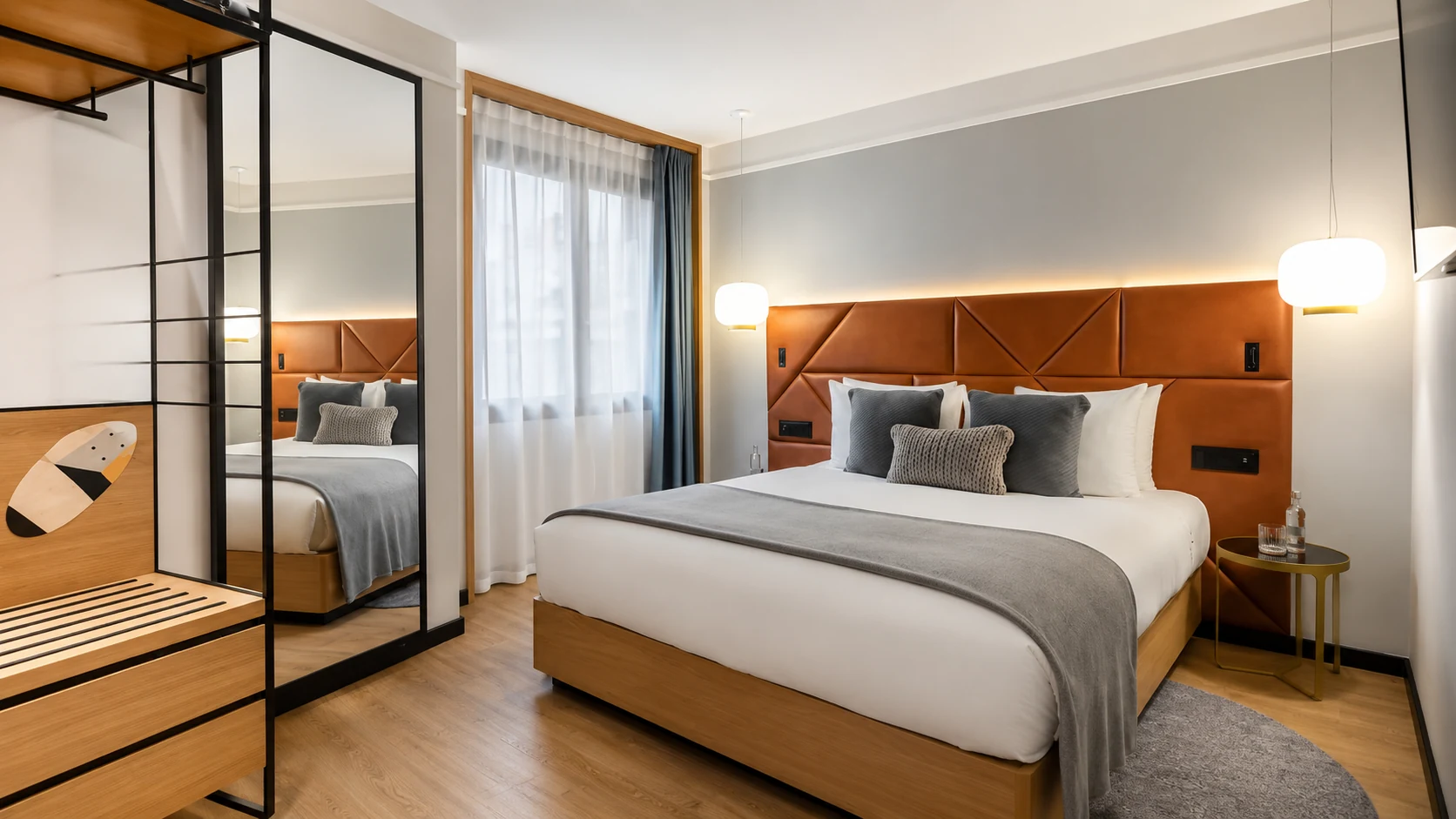 Kimpton Vividora Barcelona bathroom with marble vanity and round mirror