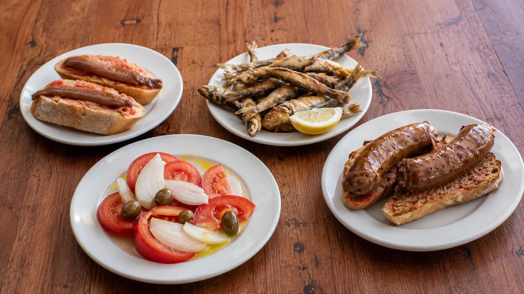 Bar La Plata Barcelona fried fish, sausage, salad, and tapas plates