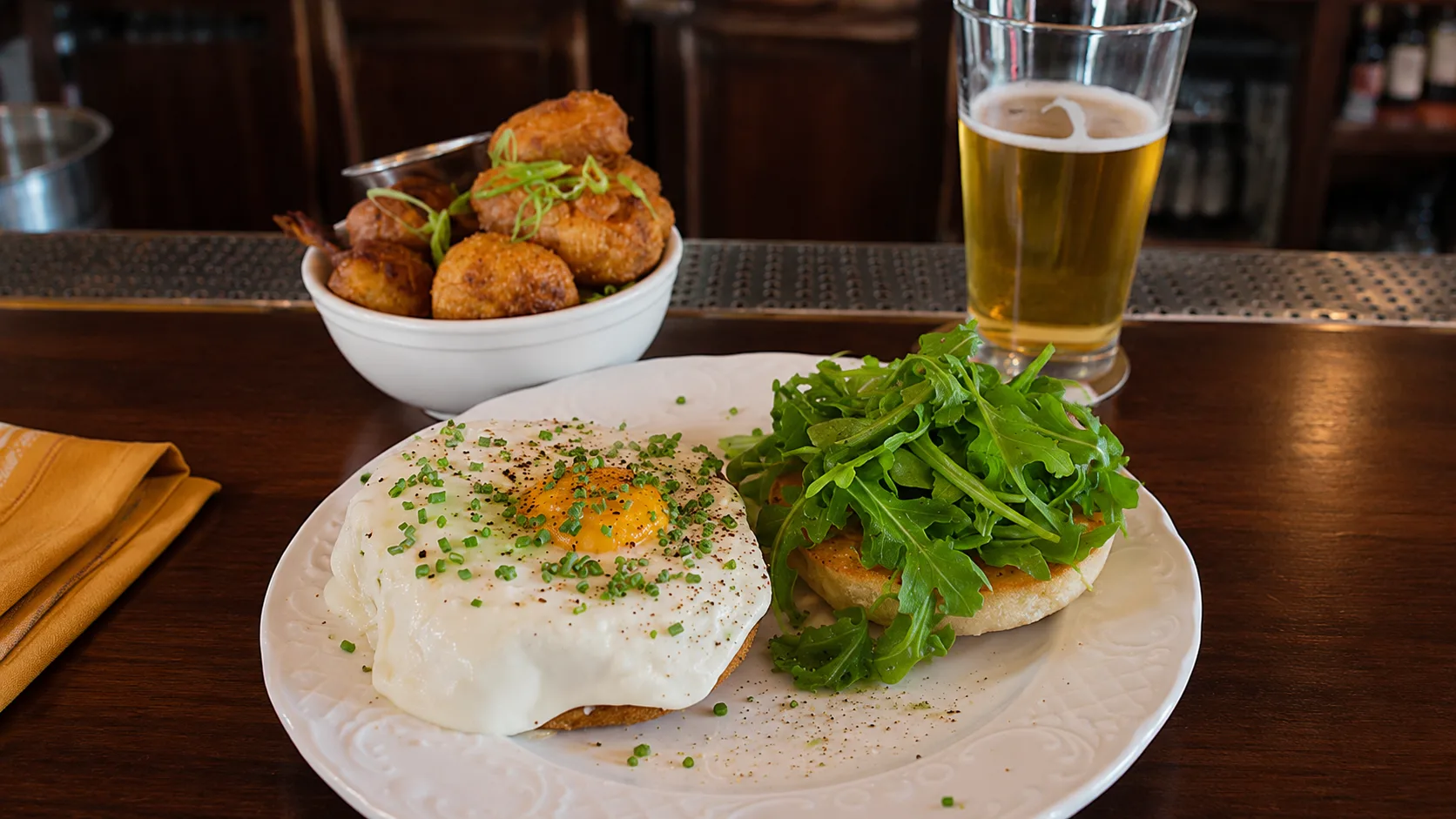 Brunch plate with egg, potatoes, and beer at Longman and Eagle Chicago