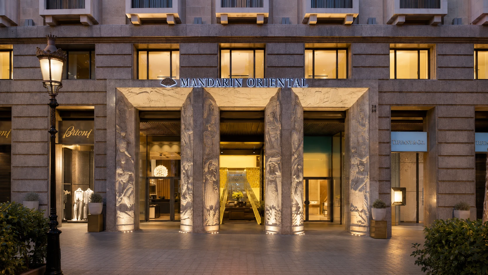 Mandarin Oriental Barcelona entrance on Passeig de Gracia with warm evening lights and luxury hotel facade
