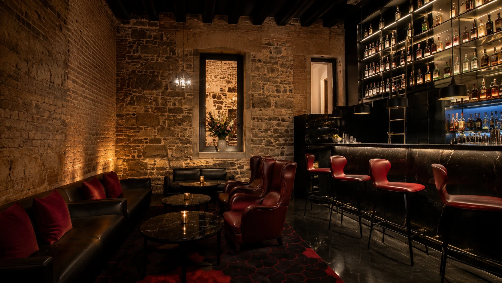 Mercer Hotel Barcelona intimate cocktail bar with stone walls, leather chairs, and warm low lighting