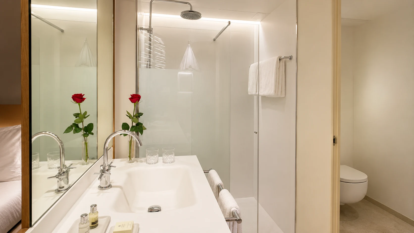 Mercer Hotel Barcelona modern bathroom with white vanity and glass shower
