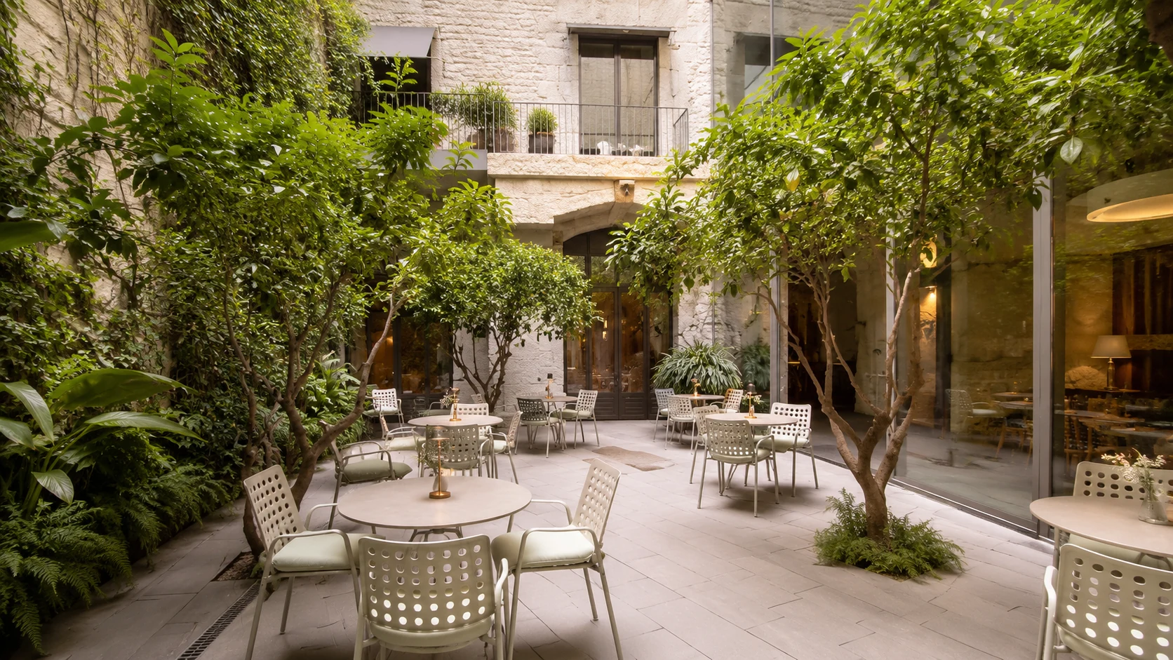Mercer Hotel Barcelona courtyard with trees and outdoor seating