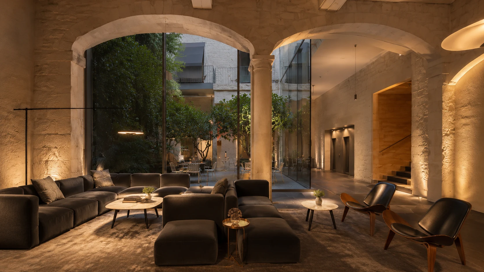 Mercer Hotel Barcelona lounge with stone arches and courtyard views