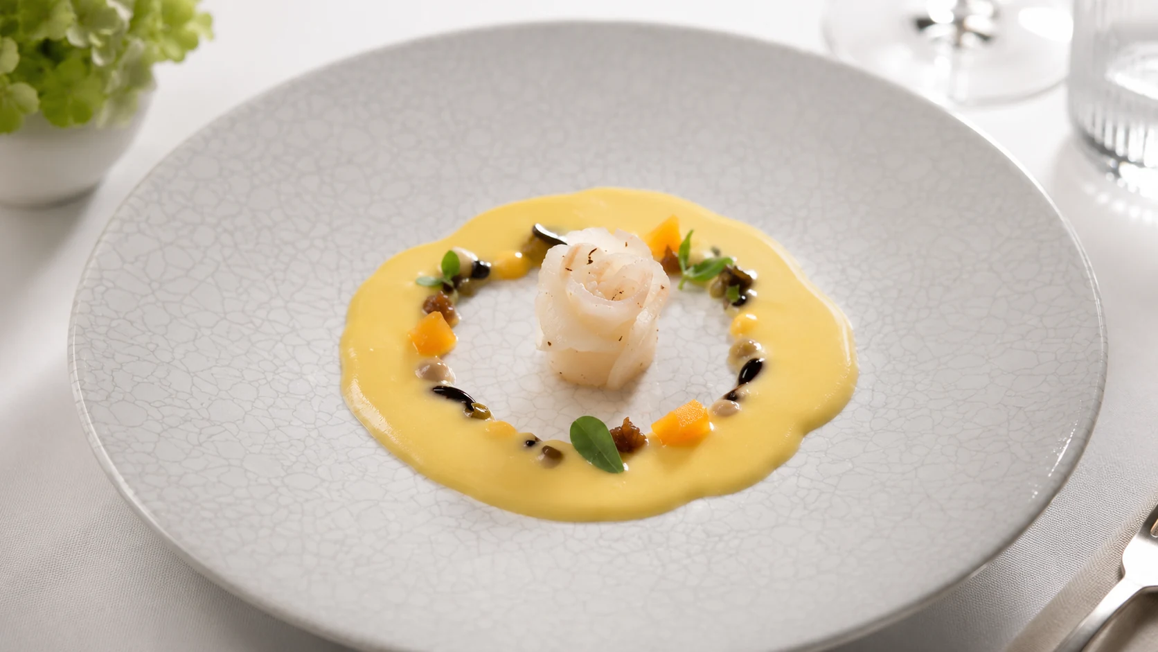 Moments Barcelona small plated dish with sauce and herbs