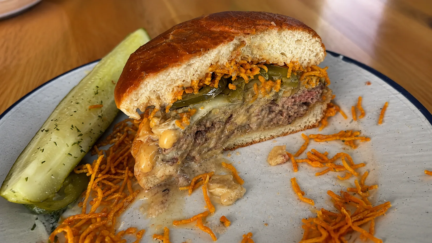 Cut Mott St burger with pickles and crispy potatoes in Chicago