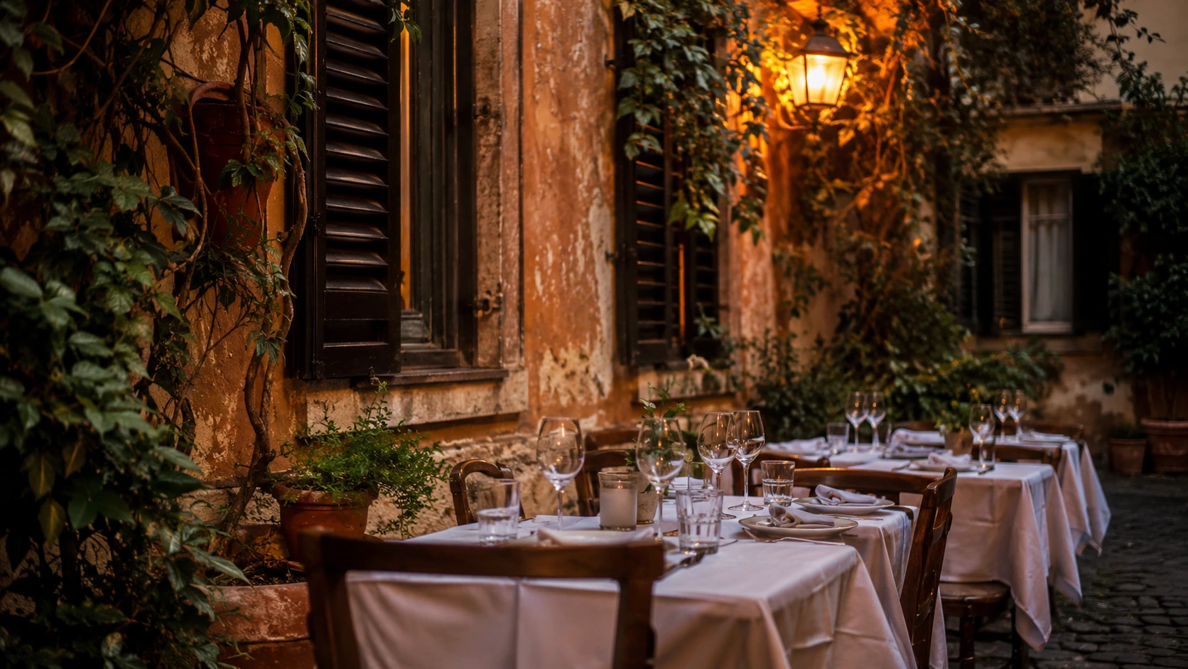 Rome cobblestone alley with trattoria tables, ivy-covered walls, and warm evening light