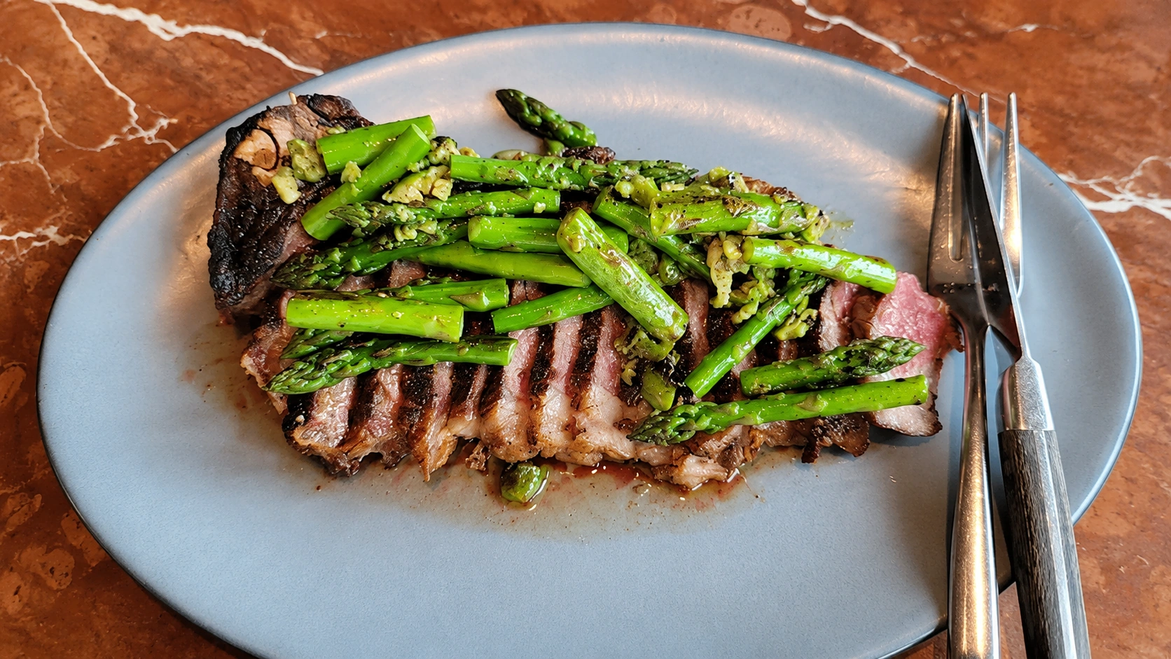 Sliced steak with asparagus at Rose Mary in Chicago