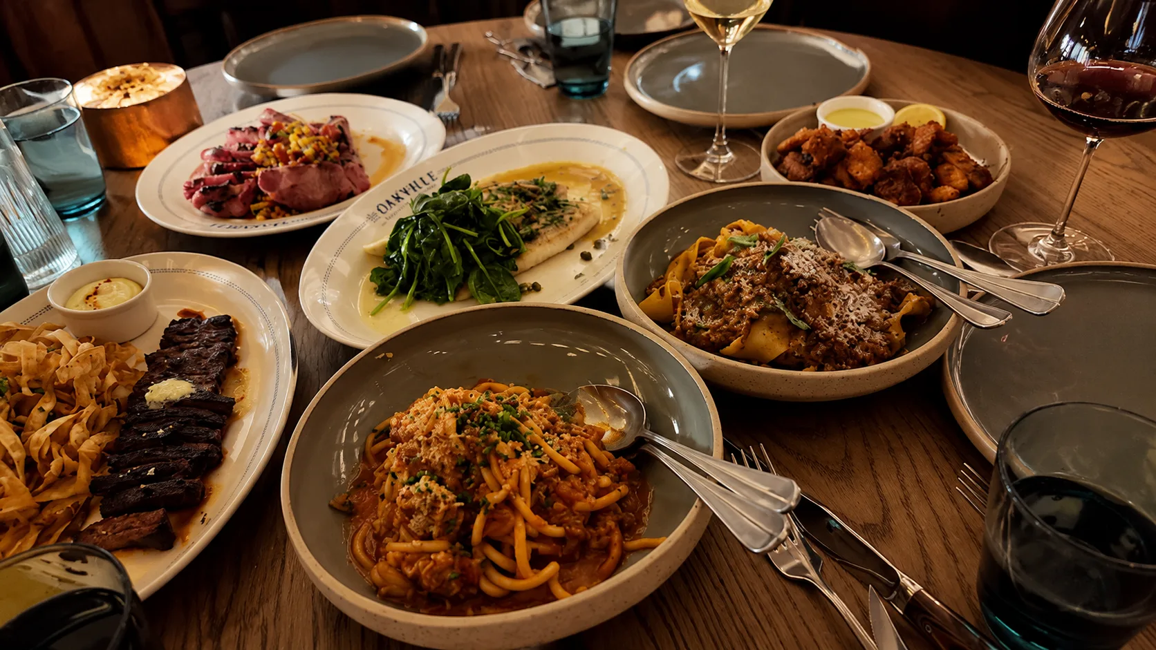Shared pasta, steak, and vegetables at The Oakville Grill and Cellar Chicago