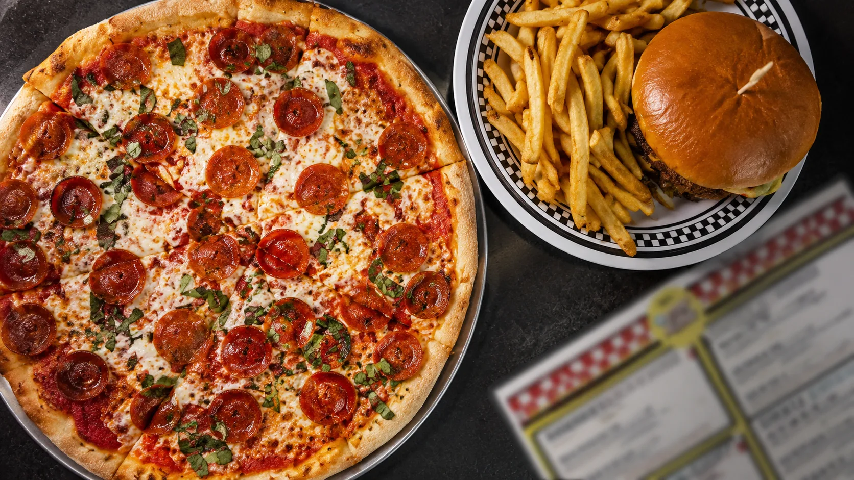 Pizza and burger with fries at The StopAlong in Chicago