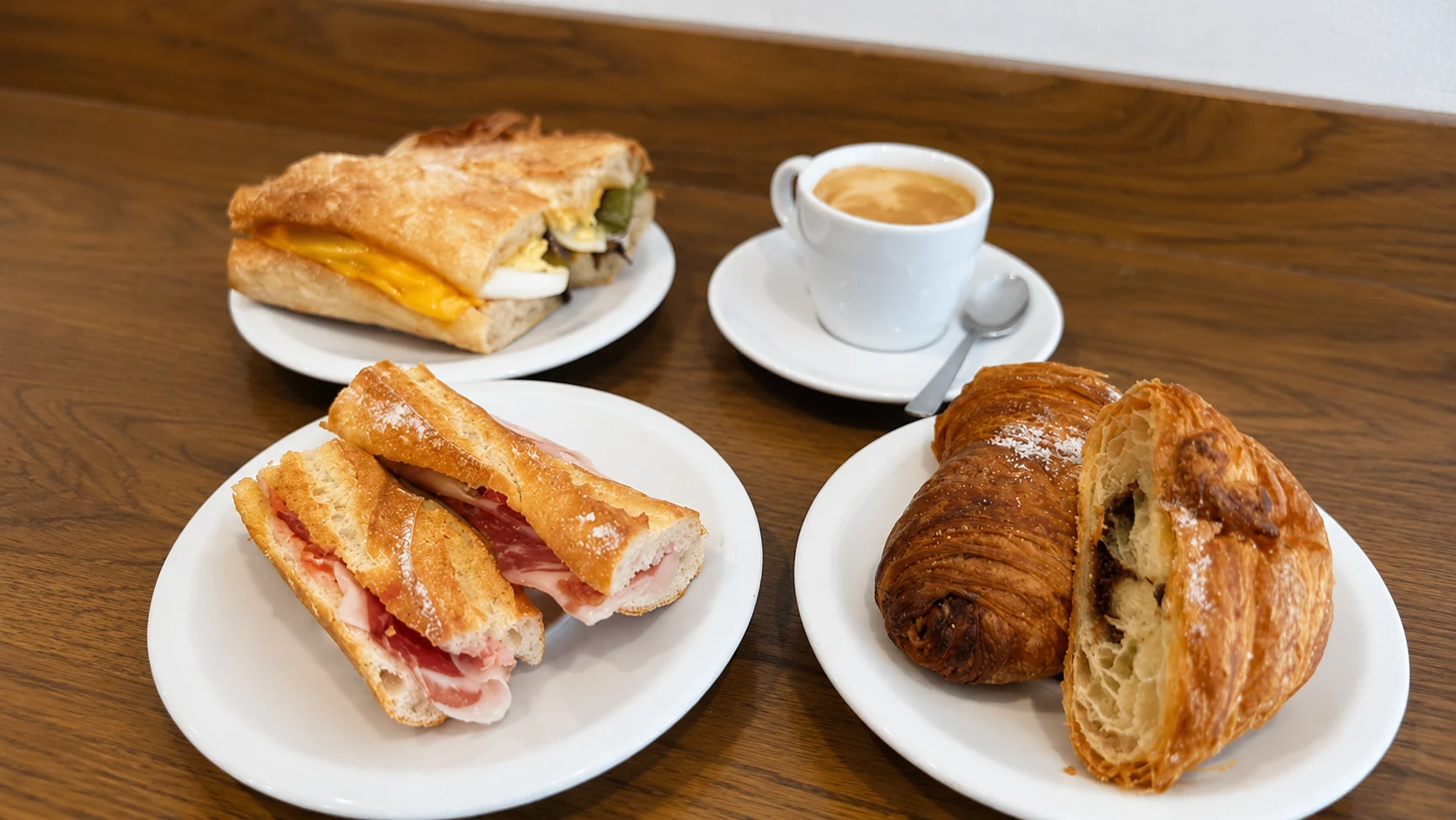 Villa Bakery Barcelona croissant, pastry, bocadillo, and espresso on a cafe table