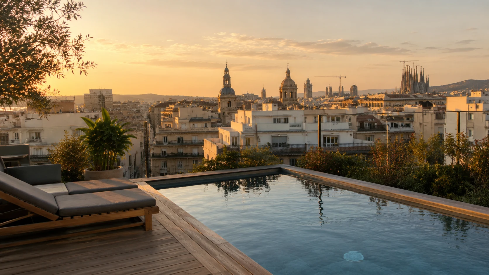Rooftop infinity pool at a Barcelona boutique hotel at golden hour with city views